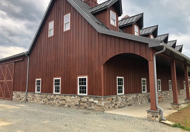 tan Stone veneer installed on a red barn